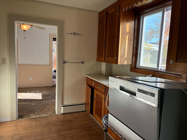 kitchen featuring stainless steel dishwasher, ceiling fan, dark wood-type flooring, and crown molding