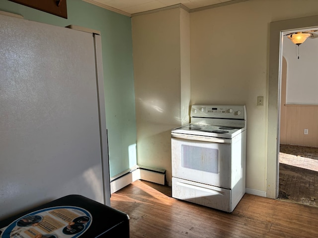 kitchen featuring hardwood / wood-style floors, white appliances, and crown molding