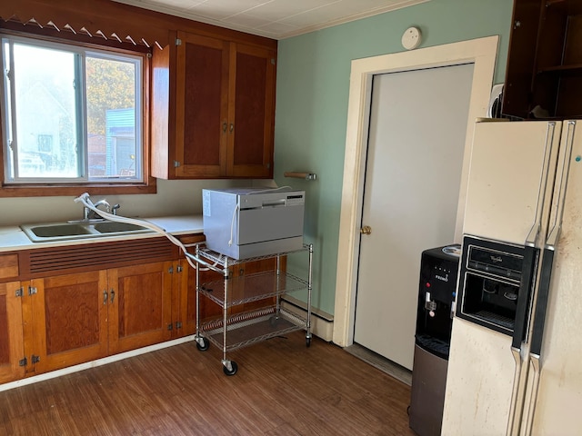 kitchen with white refrigerator with ice dispenser, dark hardwood / wood-style floors, and sink