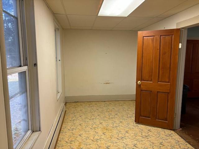 hallway with a paneled ceiling