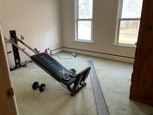 exercise room featuring carpet flooring and baseboard heating