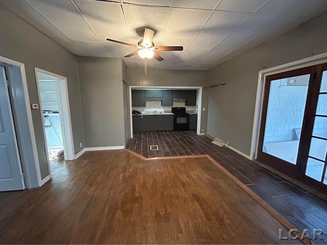 unfurnished living room with ceiling fan and dark hardwood / wood-style floors