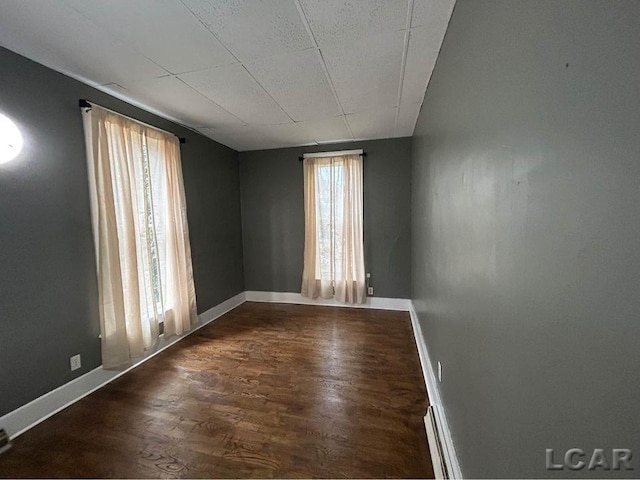 spare room with dark wood-type flooring