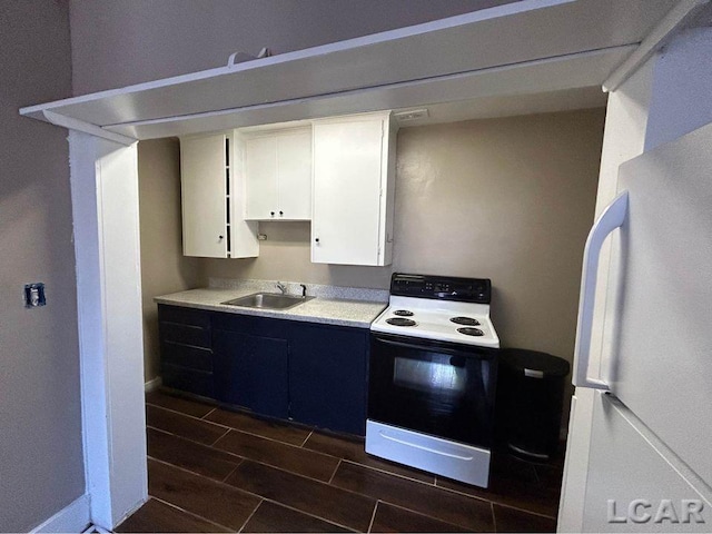 kitchen featuring white appliances, white cabinetry, and sink