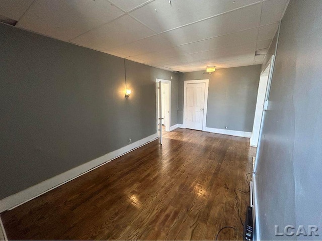 spare room featuring dark wood-type flooring