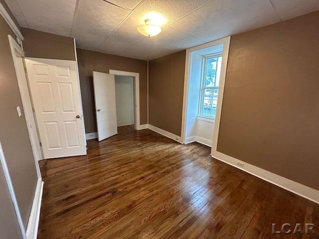 unfurnished bedroom with dark hardwood / wood-style floors