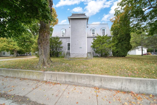 view of side of home featuring a lawn