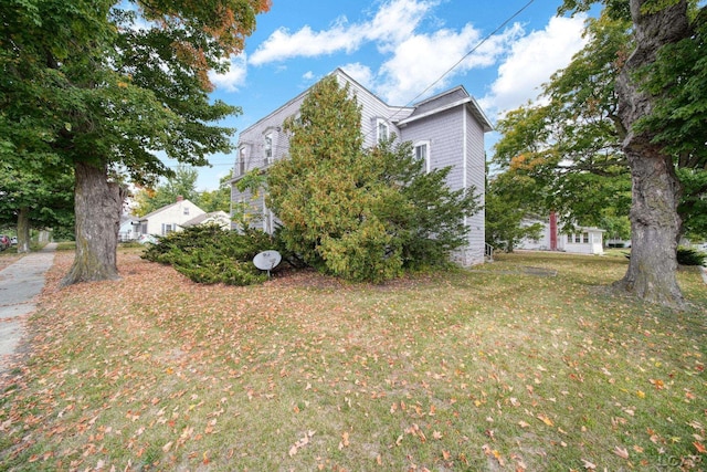 view of side of home with a lawn