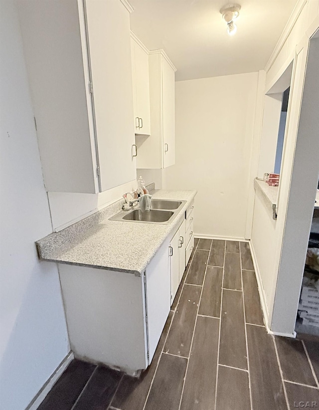 kitchen featuring white cabinets and sink