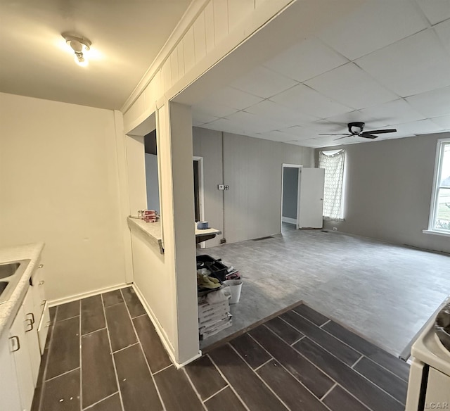 kitchen featuring ceiling fan and white cabinets