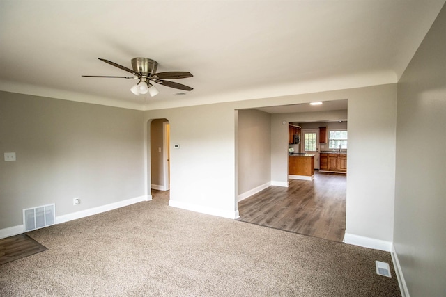 empty room with carpet flooring and ceiling fan