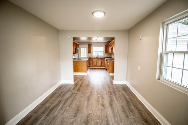 7029 Silver Lake Rd, Linden, MI 48451 - kitchen featuring brown cabinets, dark wood-type flooring, and stainless steel microwave