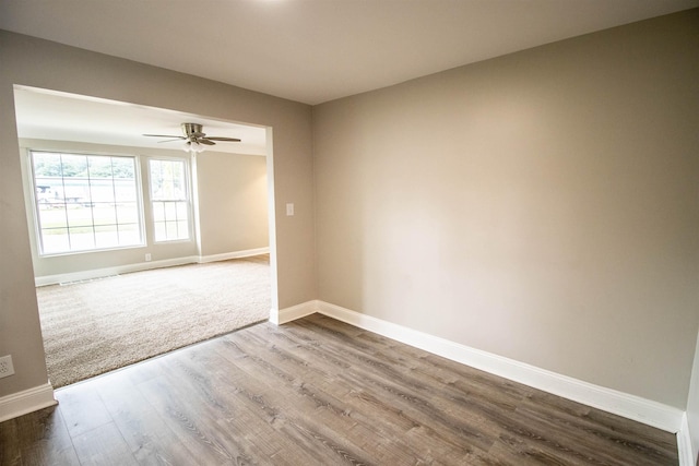 unfurnished room with hardwood / wood-style flooring and ceiling fan