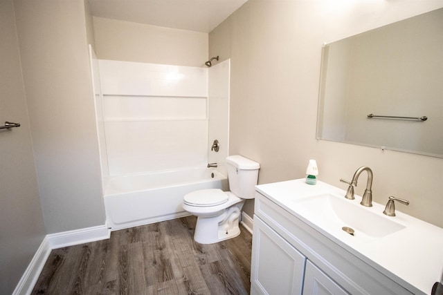 full bathroom with hardwood / wood-style flooring,  shower combination, toilet, and vanity