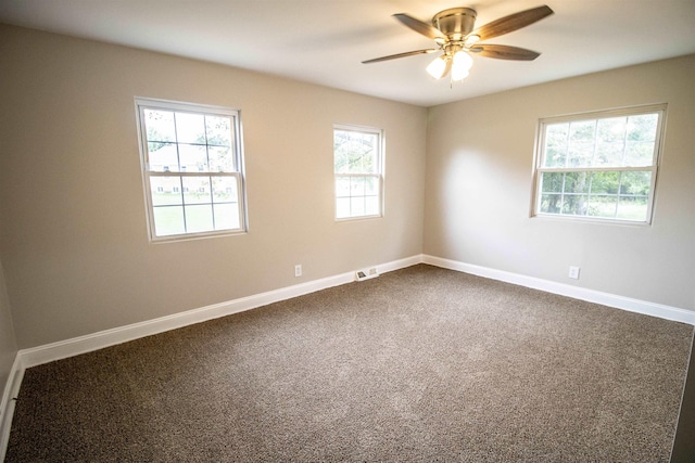 spare room featuring carpet flooring and ceiling fan