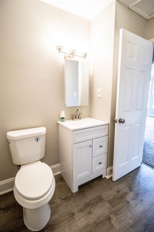 bathroom with vanity, wood-type flooring, and toilet