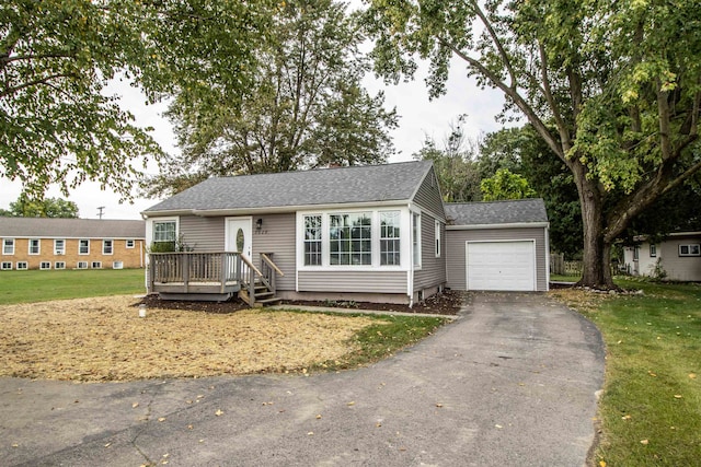 view of front of home with a garage and a front yard