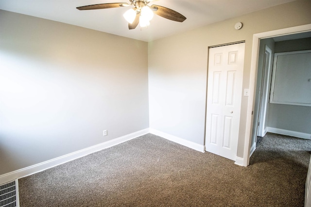 7029 Silver Lake Rd, Linden, MI 48451 - unfurnished bedroom featuring dark colored carpet, a closet, and a ceiling fan