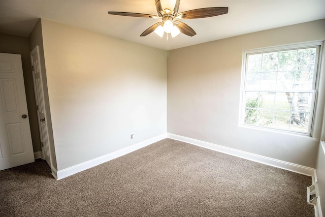 carpeted empty room featuring ceiling fan