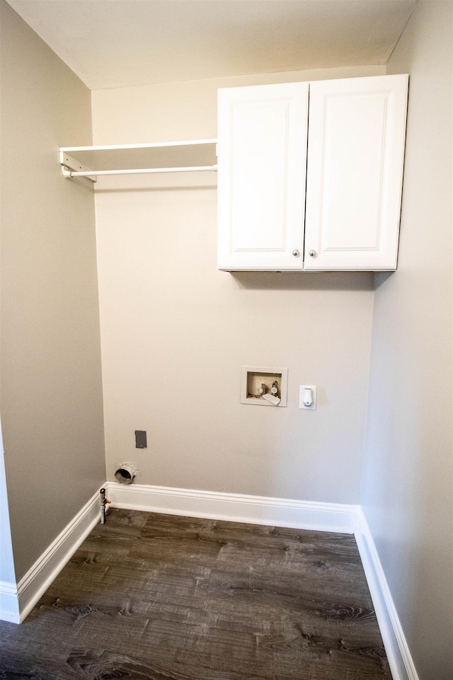 clothes washing area with hookup for a washing machine, dark wood-type flooring, and cabinets