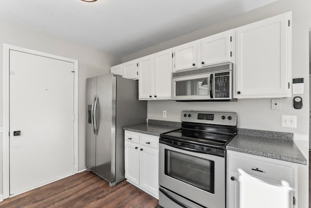 kitchen featuring dark hardwood / wood-style flooring, stainless steel appliances, and white cabinetry