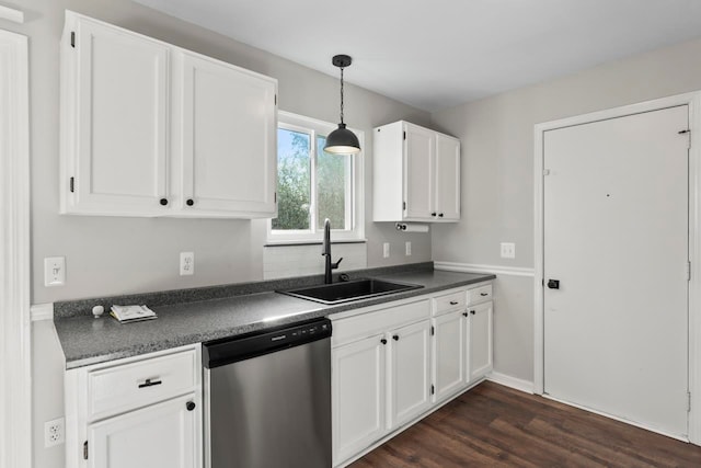 kitchen with pendant lighting, dark wood-type flooring, white cabinets, sink, and stainless steel dishwasher