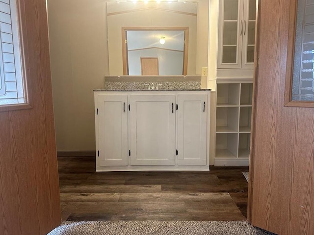 bathroom with vanity, wood-type flooring, and lofted ceiling