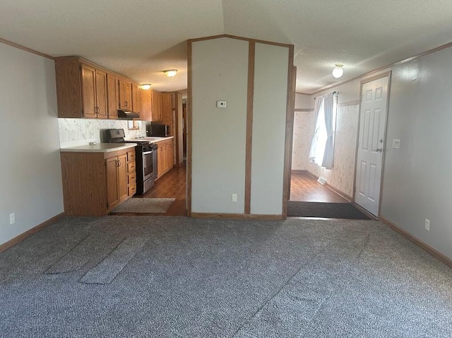 kitchen featuring a textured ceiling, electric range, and dark carpet