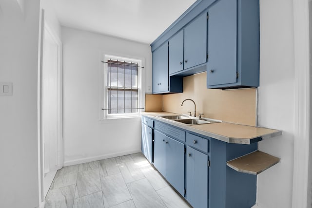 kitchen with blue cabinetry and sink