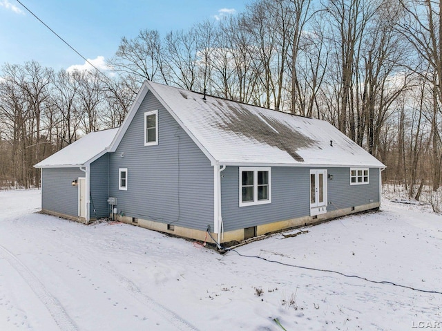 snow covered house featuring french doors