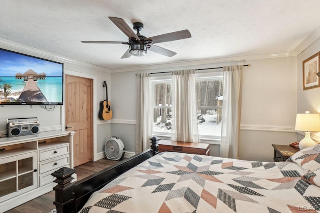 bedroom featuring crown molding, ceiling fan, dark wood-type flooring, and a textured ceiling