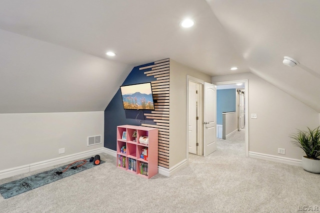 recreation room with lofted ceiling and carpet flooring