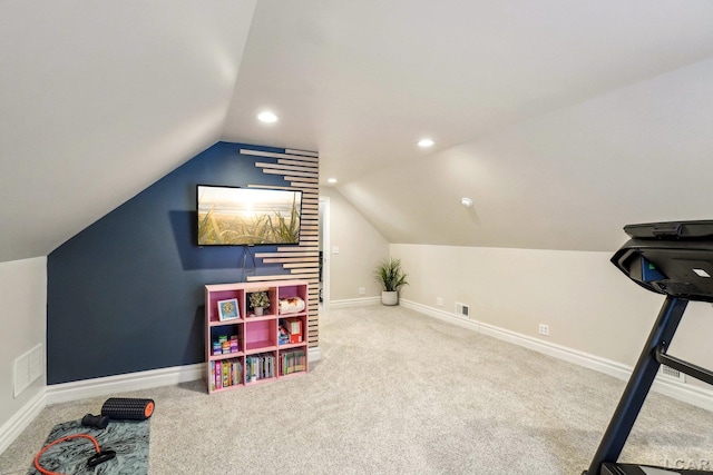 interior space with vaulted ceiling and carpet