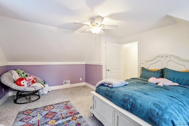 bedroom with ceiling fan, light colored carpet, and vaulted ceiling