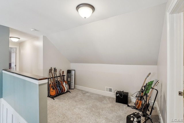 rec room featuring lofted ceiling and light carpet