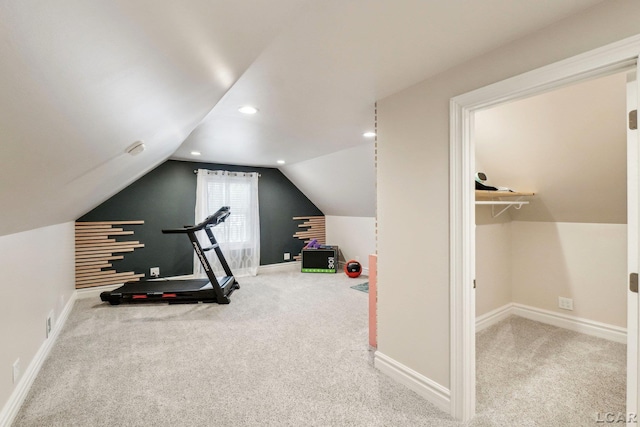 workout area with carpet flooring and vaulted ceiling