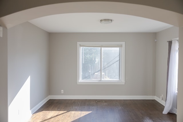 unfurnished room featuring dark wood-type flooring