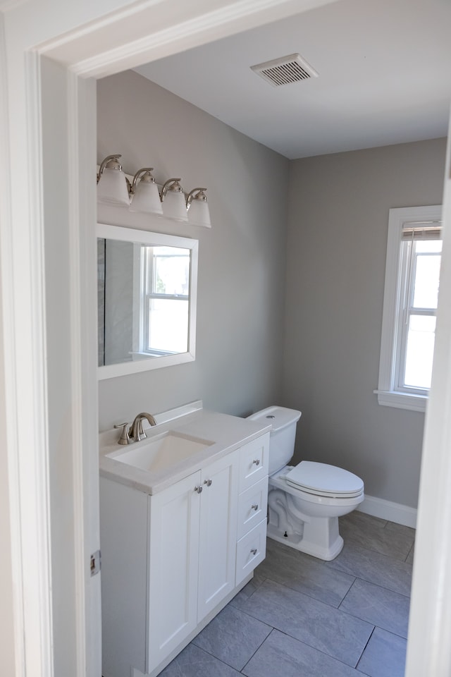 bathroom featuring vanity and toilet