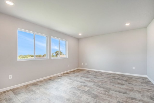 unfurnished room with light wood-type flooring