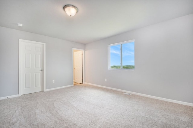 unfurnished room with light carpet