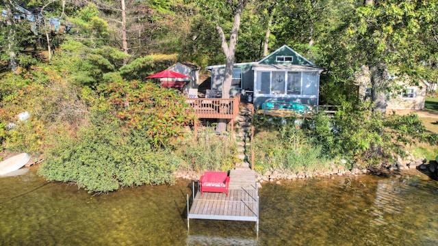 dock area with a water view and a view of trees