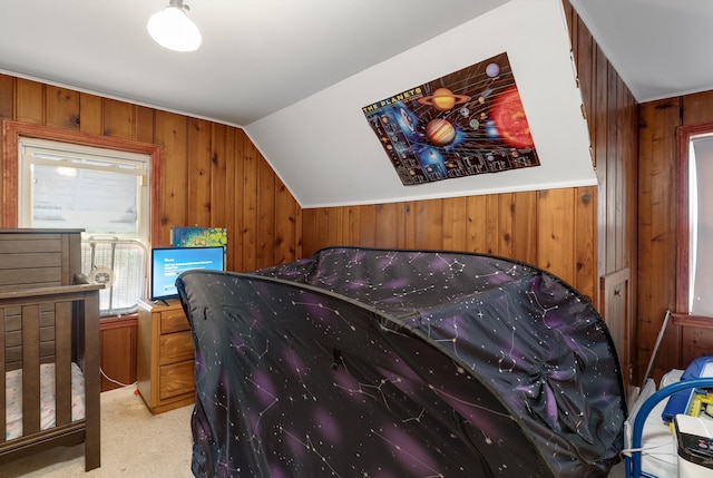 bedroom with light carpet, vaulted ceiling, and wood walls