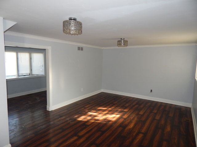 unfurnished room featuring ornamental molding and dark wood-type flooring