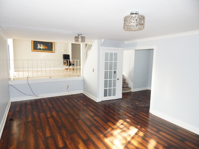 unfurnished living room with dark hardwood / wood-style flooring and crown molding