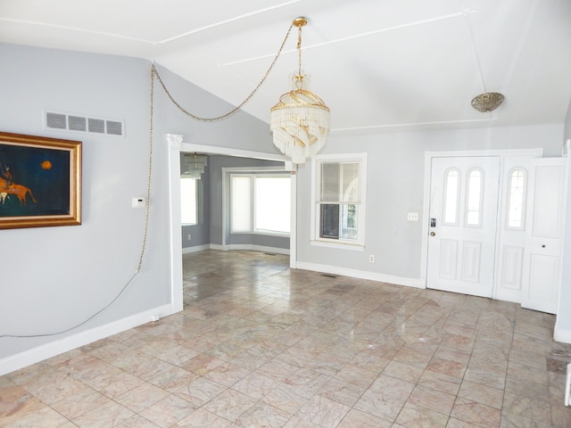 entryway featuring vaulted ceiling and a notable chandelier