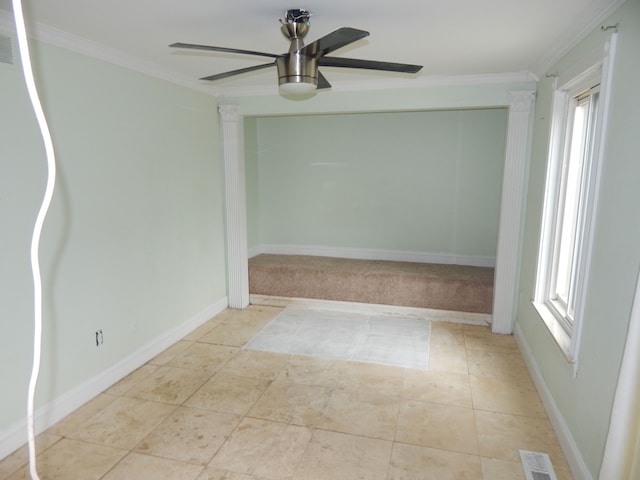 tiled empty room featuring crown molding and ceiling fan