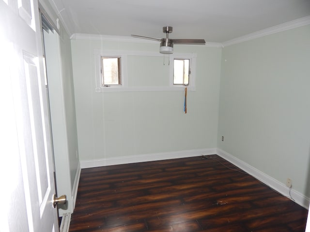 spare room featuring a wealth of natural light, dark hardwood / wood-style floors, and ornamental molding