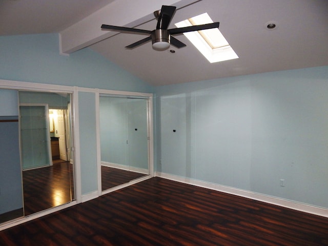 unfurnished bedroom featuring dark hardwood / wood-style floors, ceiling fan, and lofted ceiling with skylight