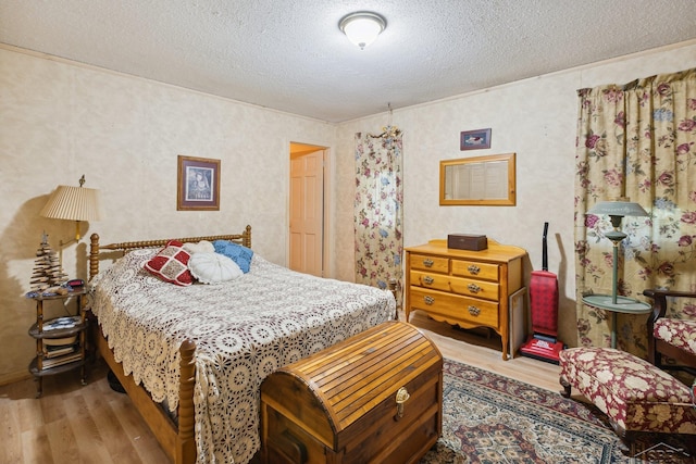 bedroom featuring hardwood / wood-style floors and a textured ceiling