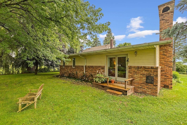 rear view of house with a yard